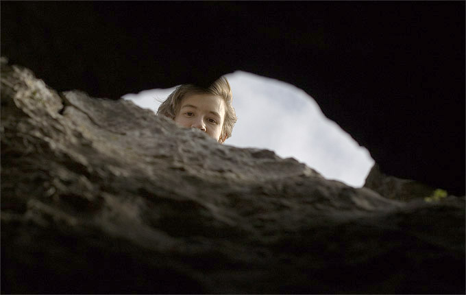 an image of Thomas above the tiny cave